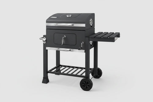 Zeleno grill na węgiel drzewny z uchwytem i składanym stołem, idealny do grillowania na świeżym powietrzu w ogrodzie.